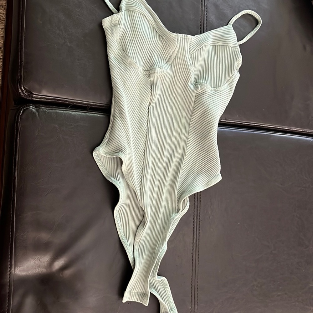 green bodysuit button at bottom